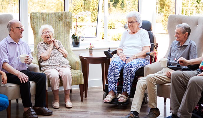 senior residents are gossiping sitting in a living room